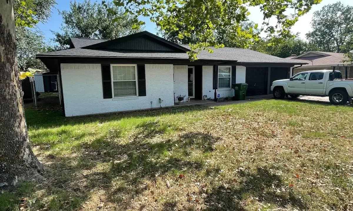 Professional roofing crew working on a residential roof in North Miami